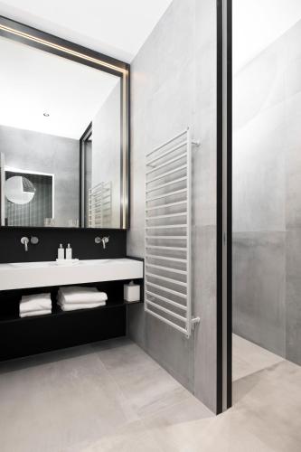 a bathroom with a sink and a mirror at Hôtel des Horlogers in Le Brassus