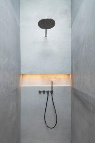 a shower in a bathroom with a shower head at Hôtel des Horlogers in Le Brassus