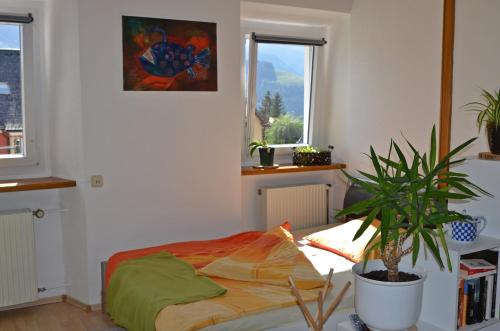 a bedroom with a bed and a potted plant at Seraphine in Tauplitz
