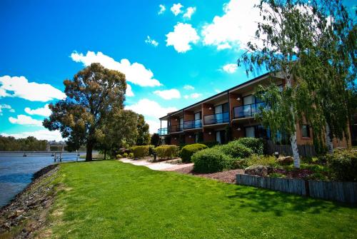 a building next to a body of water at Club Mulwala Resort in Mulwala