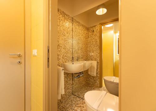 a bathroom with a sink and a toilet at Por Santa Maria Apartment in Florence