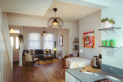 a living room with a bed and a room with a living room at Old Town Cottage in Old Town