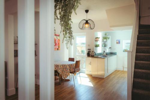 a kitchen and a dining room with a table and a dining roomiasm at Old Town Cottage in Old Town