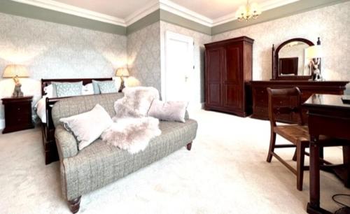 a living room with a couch and a piano at Moffat House in Moffat
