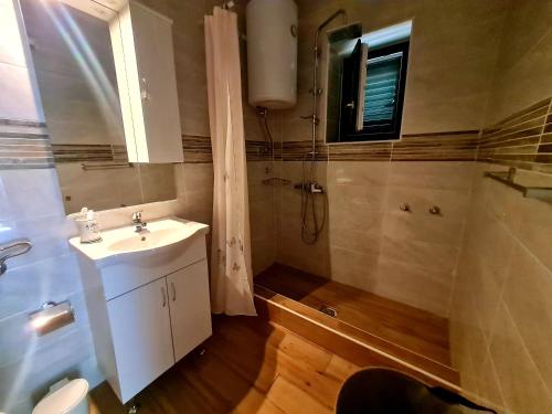 a bathroom with a sink and a shower at Apartment Sunshine in Mali Lošinj