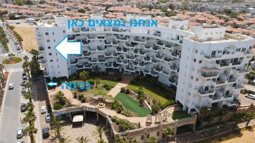 an aerial view of a building with a blue sign on it at דירה בטורקיז in H̱adera