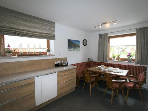 a kitchen and dining room with a table and chairs at Apartment Brettfall Blick by Interhome in Strass im Zillertal