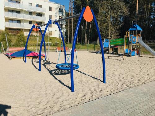 an empty playground in the sand in a park at AQUAMARINA ONYX GOLD in Międzyzdroje