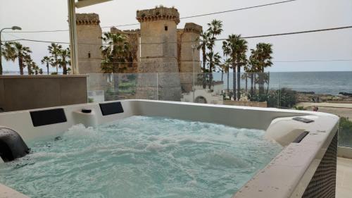 a bath tub with water in it on a balcony at Residenza 4 Colonne CONTEMPORANEA in Santa Maria al Bagno