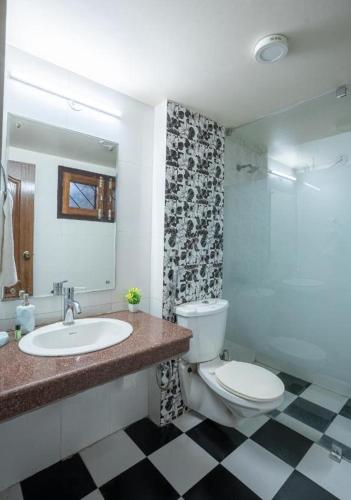 a bathroom with a toilet and a sink at Karinya Villas in Nainital