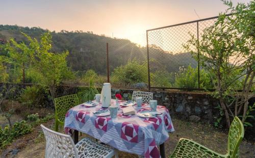 a table with a red and white table cloth at Karinya Villas in Nainital