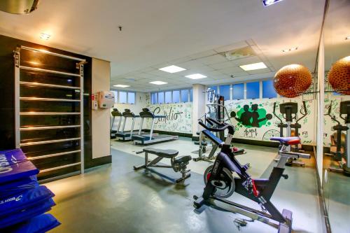 a gym with bikes and weights in a room at Quality Rio de Janeiro - Barra da Tijuca in Rio de Janeiro
