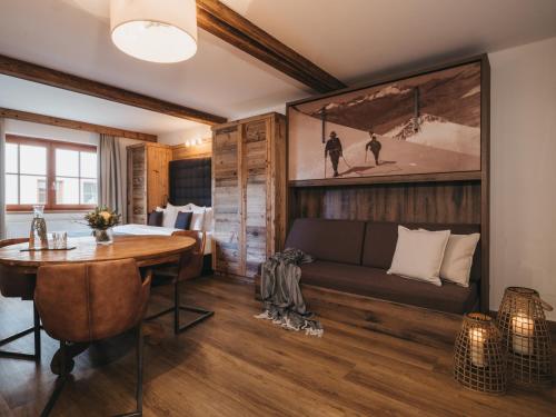 a living room with a couch and a table at VAYA Kaprun inklusive Zell am See Kaprun Sommer Karte in Kaprun