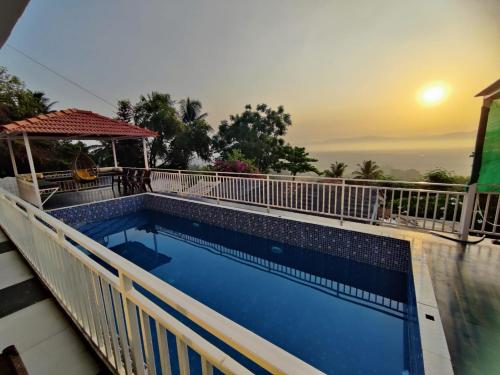 a swimming pool on the roof of a house at WhiteHouse Homestay by Oxystays Hospitality in Alibaug
