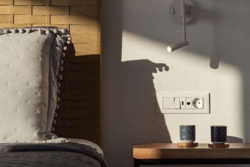 a shadow of a person taking a picture of a bed at Margaret Villa - Pool, Heated Spa Whirlpool & BBQ, By ThinkVilla in Angeliana