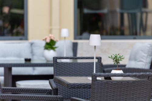 a table with chairs and a lamp on a patio at Hotel Auditorium in Bari