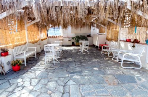 a patio with white chairs and tables in a building at Hotel Villa La Brise in Sanremo