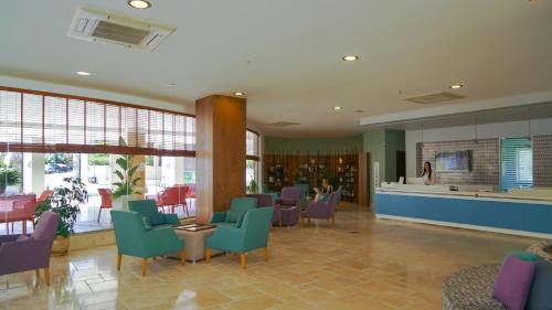 a waiting area in a hospital with chairs and tables at Barut B Suites in Side