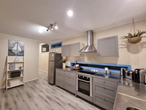 a large kitchen with a stove and a refrigerator at Vitamin Sea Beach House with outdoor Spa in Rosebud