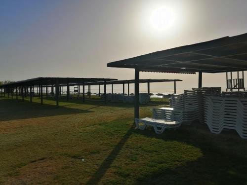 a group of chairs under a pavilion in a field at Orange&Lemon Villas Çamyuva in Kemer