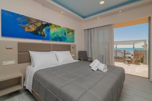 a bedroom with a large bed and a large window at Sea Diamond Suites in Laganas