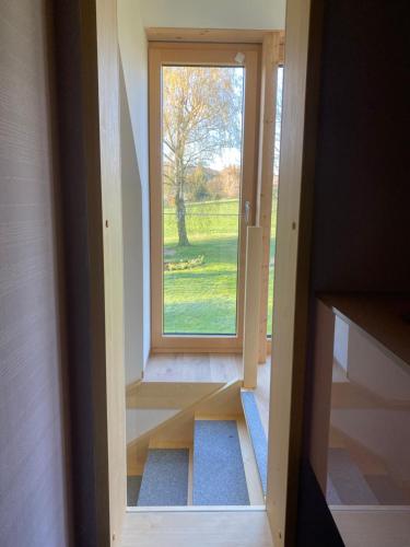 a door leading into a room with a window at Haflingerstall in Neudiehman