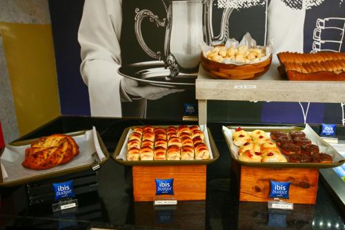 a buffet with trays of pastries and other desserts at ibis budget RJ Copacabana in Rio de Janeiro