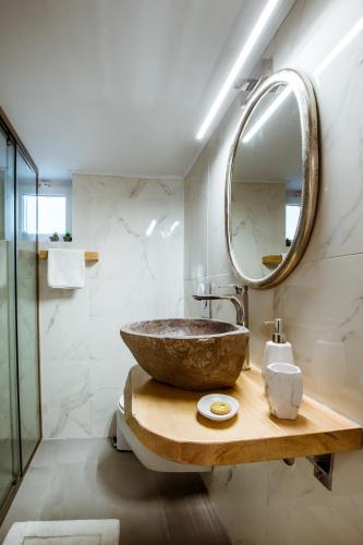 a bathroom with a bowl sink and a mirror at Villa Archontiki I - Private Pool in Vryses