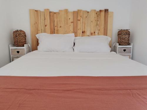 a bedroom with a large white bed with two night stands at ** Nouveau ** Le Jardin De La Plage - Appartement avec extérieur in Saint-Jorioz