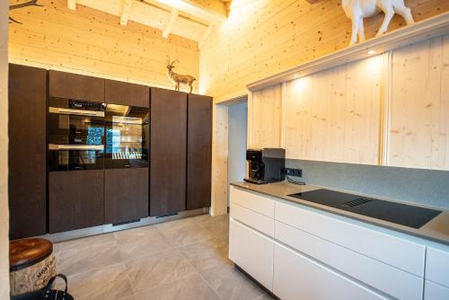 a kitchen with wooden walls and cabinets and a counter top at Chalet Hochkrimml 43 in Krimml