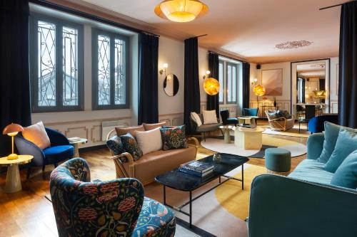 a living room with couches and chairs at Le Saint Gervais Hotel & Spa Handwritten Collection in Saint-Gervais-les-Bains
