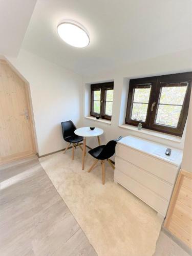 a room with a desk and two chairs and a table at Pension Adel in Český Krumlov