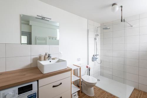 a bathroom with a sink and a toilet and a shower at New Liberty in Sainte-Mère-Église