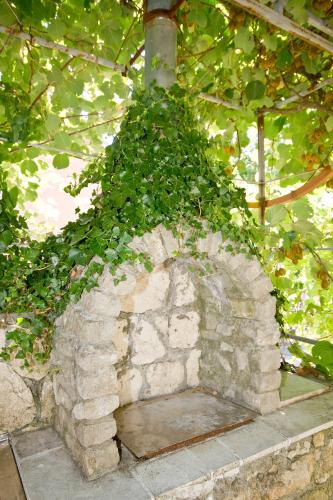 a stone oven with plants growing on top of it at Sailor's Rustic House in Virpazar