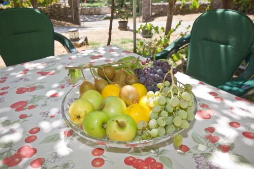 a bowl of fruit sitting on a table at Sailor's Rustic House in Virpazar