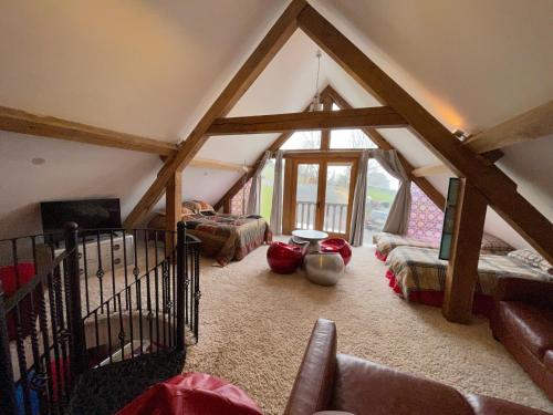 a attic room with two beds and a fireplace at Ty Nofio, Coity Bach in Brecon