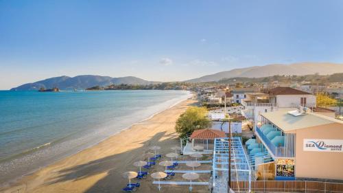 a view of a beach with umbrellas and the ocean at Sea Diamond Suites in Laganas