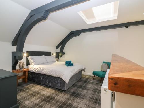 a bedroom with a bed in a room with a window at The Reception Room at The Institute Executive Apartments in Keith