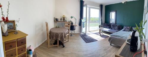 a living room with a couch and a table at River view in Randers