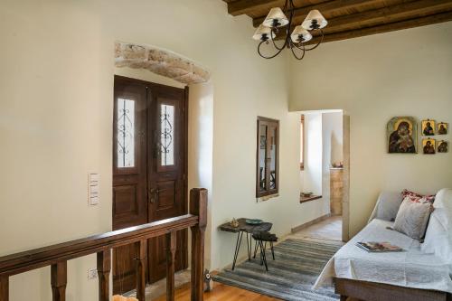 a living room with a couch and a door at Traditional Stone House Anofli 1843 Fiskardo Kefalonia in Fiskardho