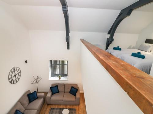 a loft bedroom with a bed and a couch at The Dance Hall at The Institute Executive Apartments in Keith