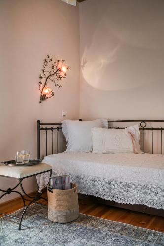 a bedroom with two beds and a table at Traditional Stone House Anofli 1843 Fiskardo Kefalonia in Fiskardho