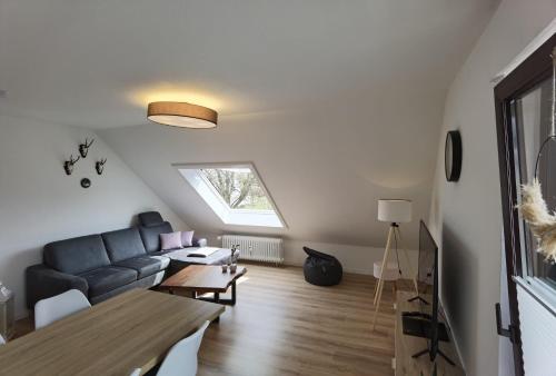 a living room with a couch and a table at Winterberg Centrum with SommerCard and bicycle cellar in Winterberg