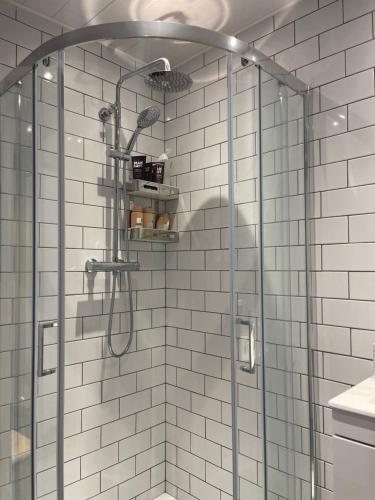 a shower with a glass door in a bathroom at Tranquil 3 bedroom town house with Sky Glass in Thornton