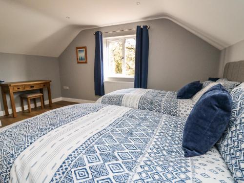 a bedroom with a bed and a window at Talarddu Cottage in Builth Wells