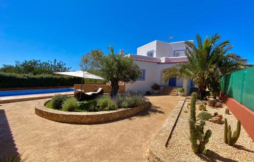 a villa with a swimming pool and a house at Villa PALMERA in Sant Jordi