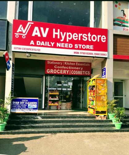 a shop with a red sign on the front of a building at Boutique Stay for Family On Manali Expressway in Lāndrān