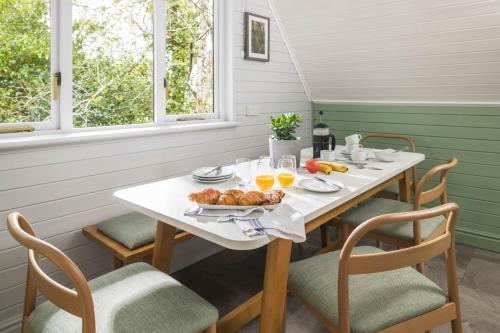 a white table with a plate of food on it at Woodbury Park Hotel & Spa in Exeter