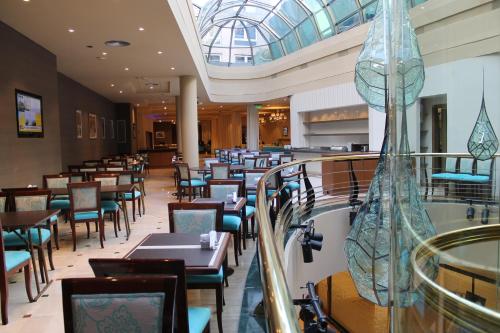 a restaurant with a bunch of tables and chairs at Howard Johnson Plaza by Wyndham Buenos Aires Florida Street in Buenos Aires