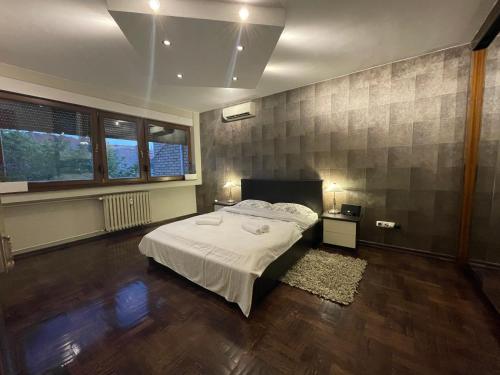 a bedroom with a white bed in a room at Riverside Luxury Apartment in Osijek